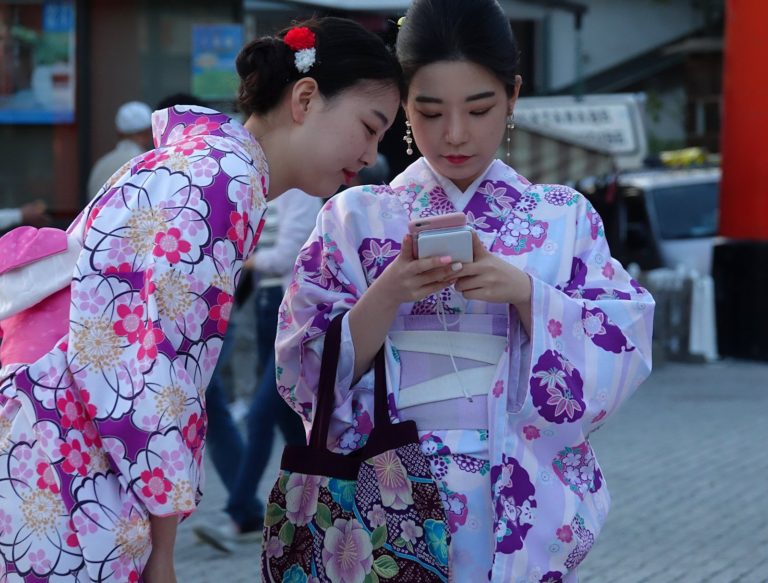 Geisha-for-day girls checking their photos.
