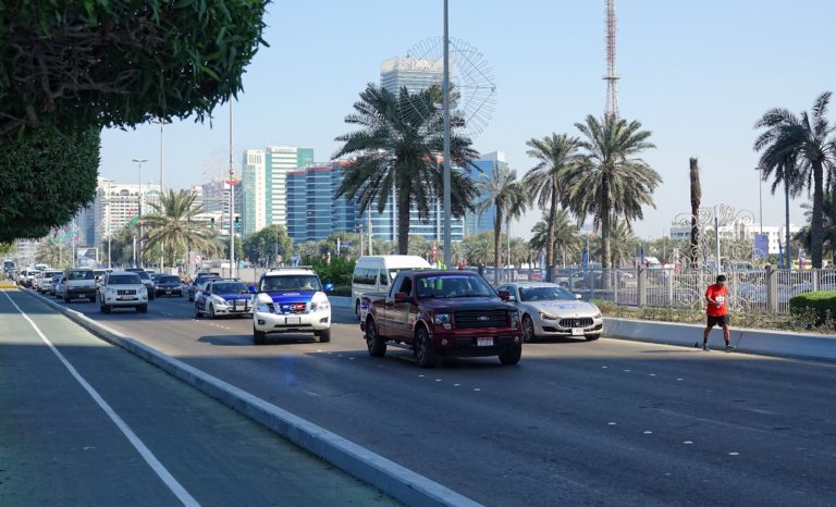 The person in last place in the Abu Dhabi Marathon 2018, holding up traffic.