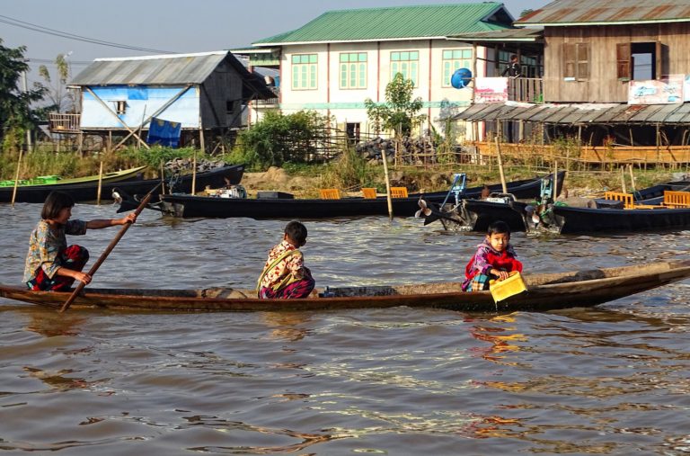 Photo of mother getting the children to school by boat.