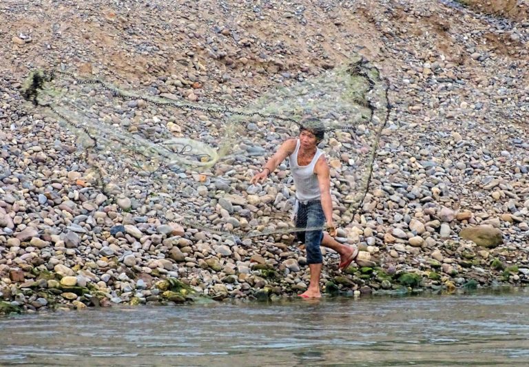 Throwing a fishing net into the Mekong