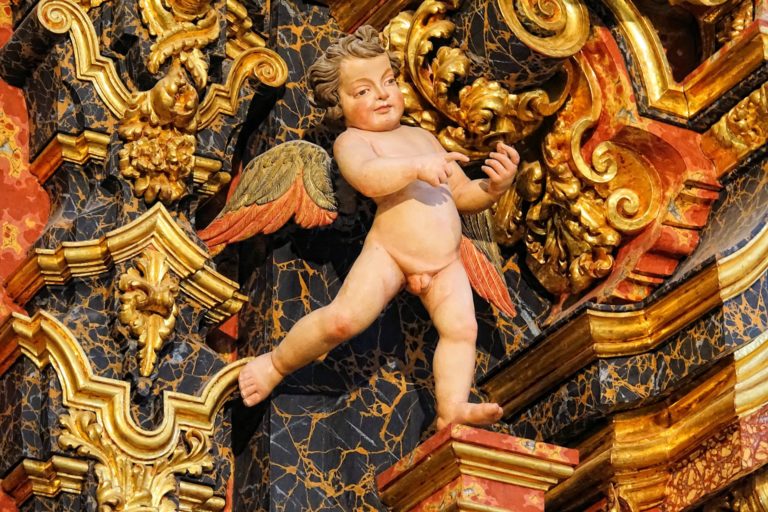 Gilded small boy in the decidedly Catholic cathedral in Granada, Spain.