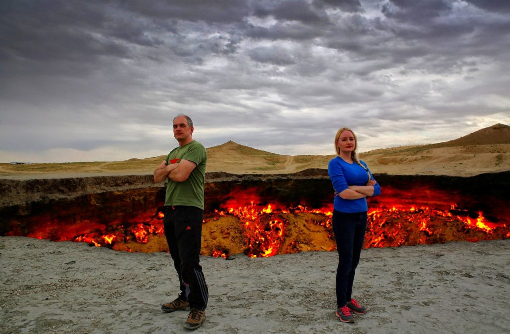 Photo of happily married couple at the gateway to Hell, in Turkmenistan.