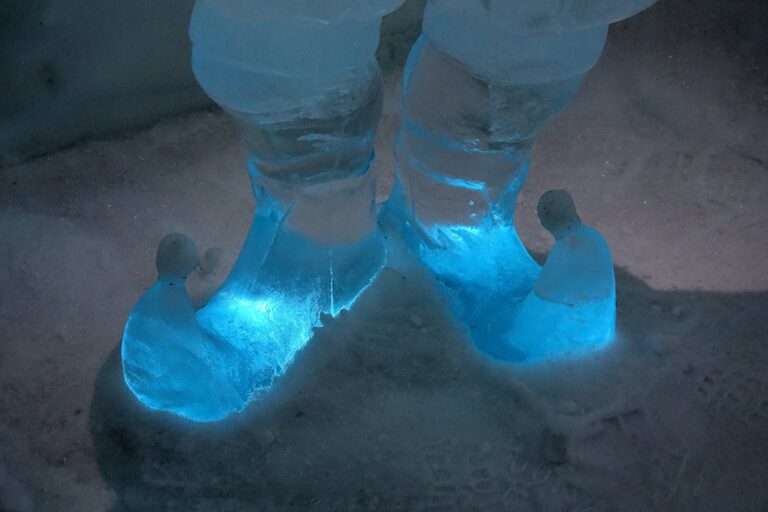 Photo of sculpture with blue feet at the Icehotel in Jukkasjärvi, Sweden.
