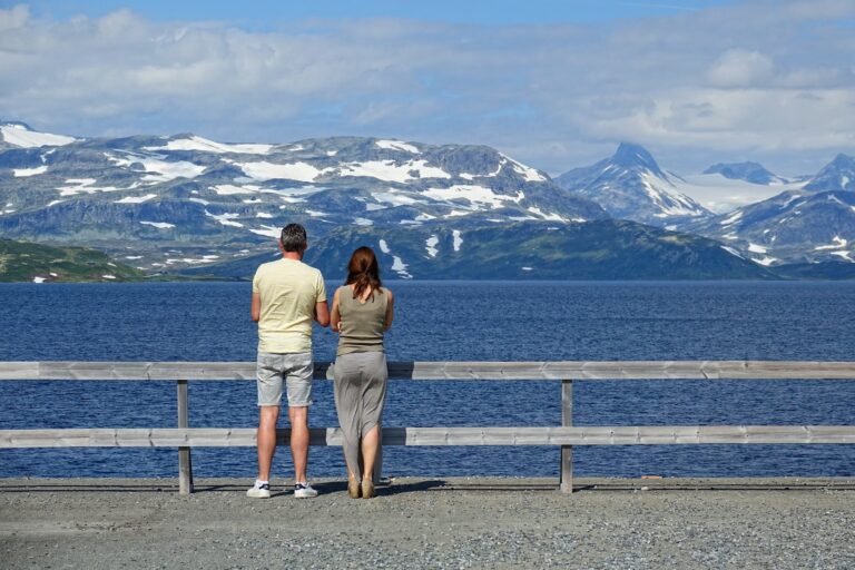Photo of tourists enjoying the lake view at Tyin, Norway.