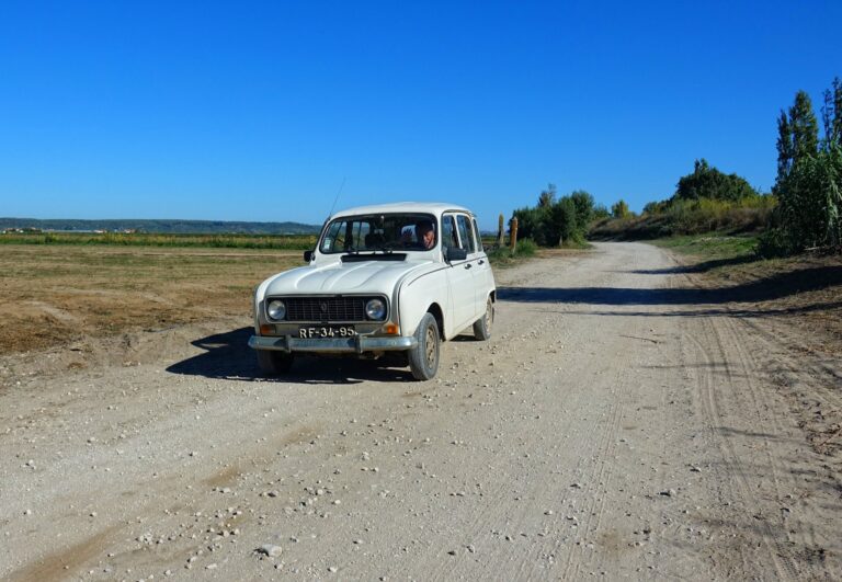 Photo of friendly farmer in an old car near Valada, Portugal.
