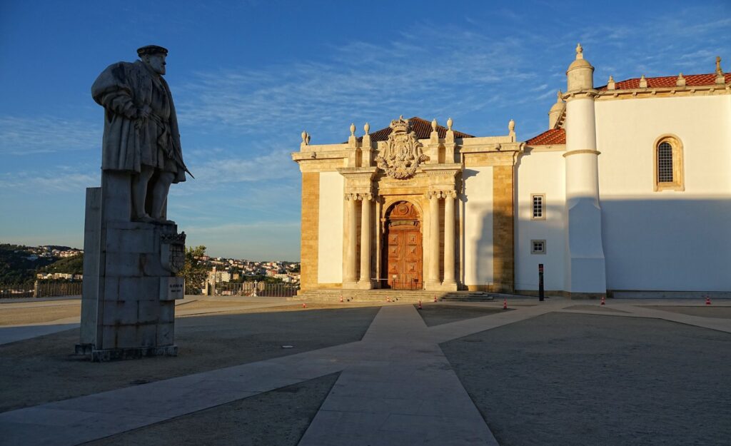 Photo of Biblioteca Joanina facade and statue outside, at the Coimbra University, Portugal.