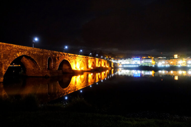Photo of Ponte Romana bridge at night, in Ponte de Lima, Portugal.