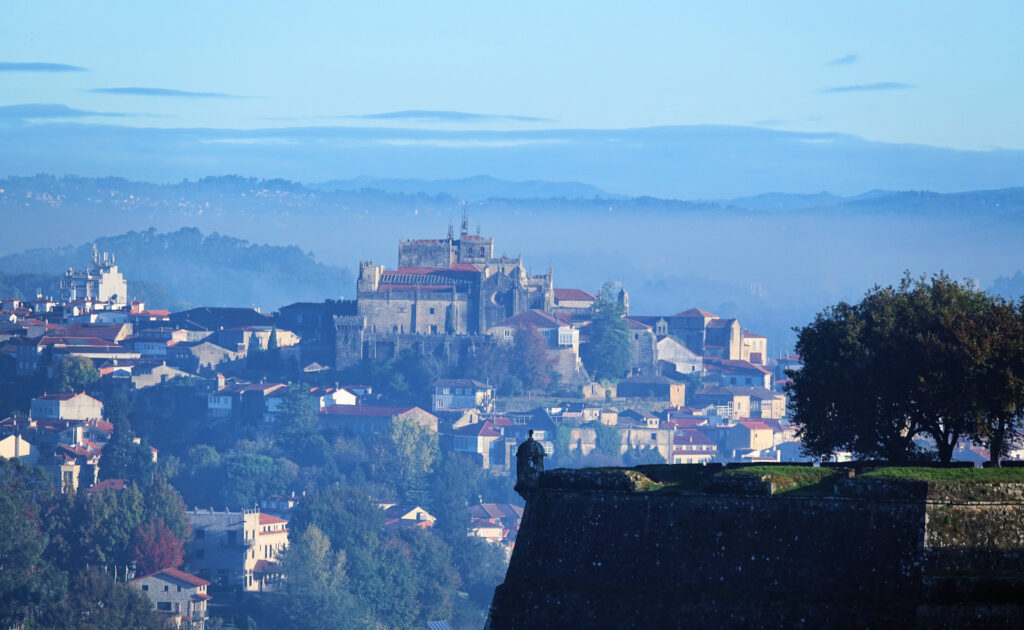 Photo showing the fortress in Valenca, Portugal in the foreground, and the cathedral in Tui, Spain in the background.