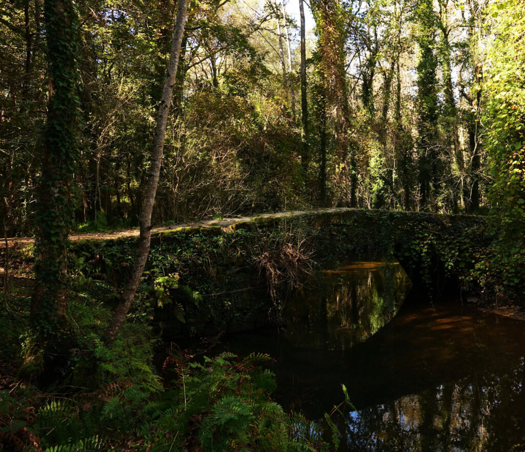 Photo of old stone bridge across Rio Louro in Galicia, Spain.