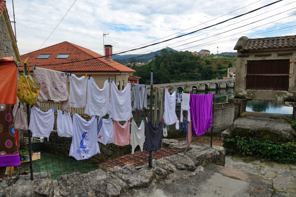 Photo of all kinds of clothes hanging out to dry next to the Camino de Santiago.