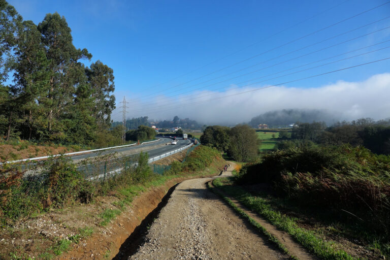 Photo of highway meeting the Camino de Santiago in Galicia, Spain.
