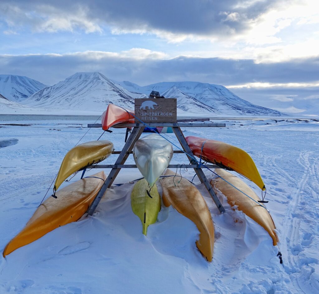 Photo of sea kayaks resting during winter in Longyearbyen, Norway